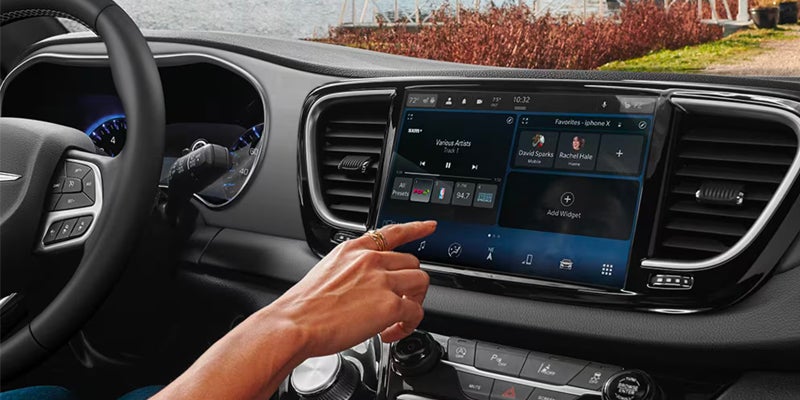 Driver interacting with the Voyager’s touchscreen infotainment