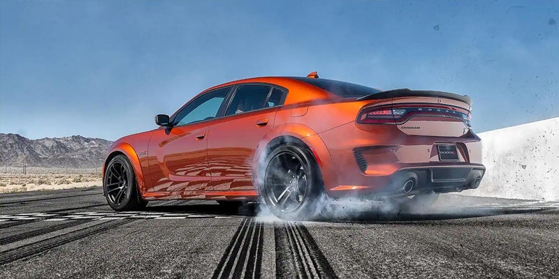 Orange 2025 Dodge Charger Daytona parked on a road