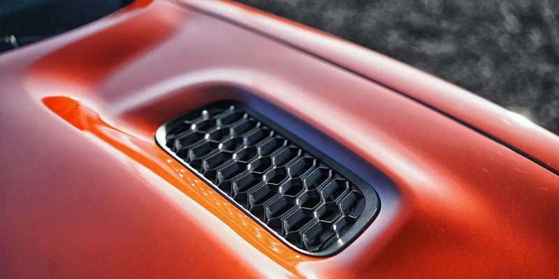 Orange speaker detail inside the 2025 Dodge Charger Daytona