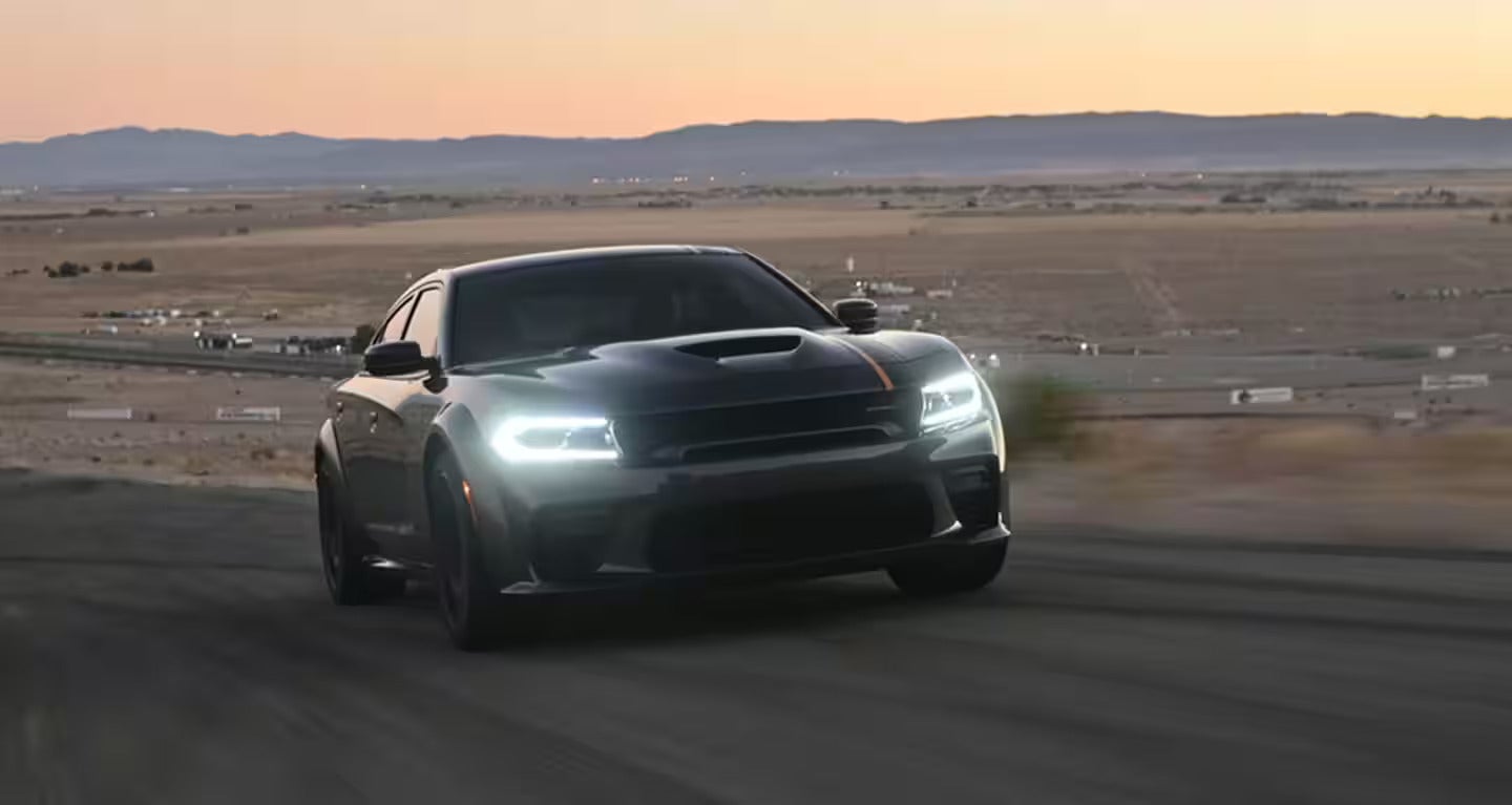 Black 2025 Dodge Charger Daytona driving on the road