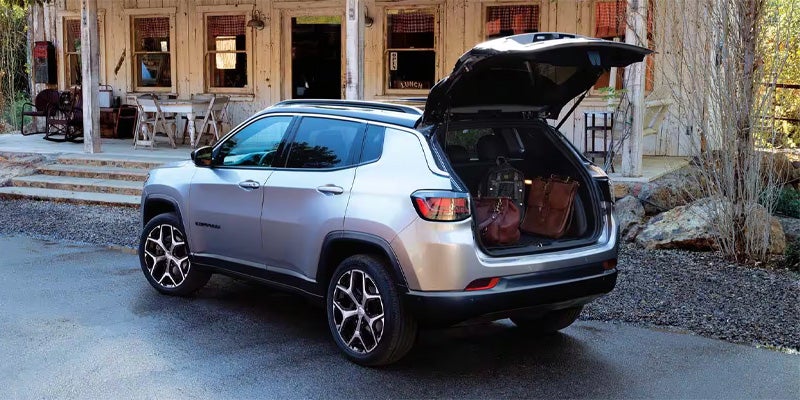 Rear door of jeep compass is opened and there aresome luggage inside the car
