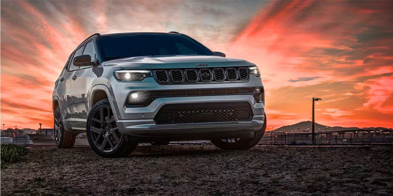 A jeep compass on open ground at sunset time