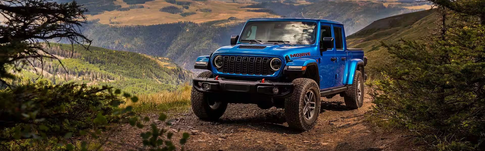 Blue Jeep Gladiator standind on mountain after off-roading