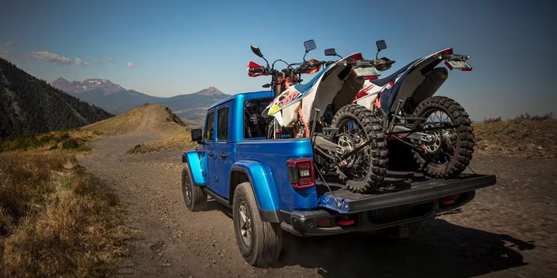 Sport bikes loaded in A blue Jeep Gladiator