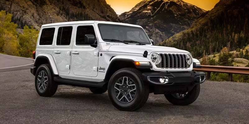 White 2025 Jeep Wrangler running on road