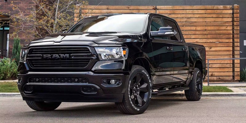 Black RAM pickup truck parked near Austin dealership